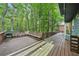 A spacious deck offers outdoor entertaining with a wooden bench and grill at 4772 Ridgewood Nw Ct, Acworth, GA 30102