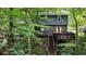 Back of home showcasing multilevel deck nestled among lush trees, perfect for outdoor enjoyment at 4772 Ridgewood Nw Ct, Acworth, GA 30102