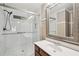 Bathroom featuring a tiled glass shower and a modern vanity with a silver-framed mirror at 4772 Ridgewood Nw Ct, Acworth, GA 30102