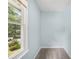 Small bedroom with light blue walls, neutral carpet, and a window overlooking the yard at 4772 Ridgewood Nw Ct, Acworth, GA 30102