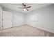 Carpeted bedroom features a ceiling fan and a bright whiteboard at 4772 Ridgewood Nw Ct, Acworth, GA 30102