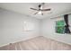 Cozy bedroom with soft carpeting, a ceiling fan, and a view of lush greenery at 4772 Ridgewood Nw Ct, Acworth, GA 30102