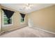 Inviting carpeted bedroom with a ceiling fan and black out curtains at 4772 Ridgewood Nw Ct, Acworth, GA 30102