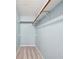 Walk-in closet with light blue walls, neutral carpet, and rods for hanging clothes at 4772 Ridgewood Nw Ct, Acworth, GA 30102