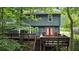 View of the back of the house featuring a spacious deck and wooded surroundings at 4772 Ridgewood Nw Ct, Acworth, GA 30102