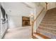 Spacious living room with a stone fireplace and staircase; the perfect place to relax and entertain guests at 4772 Ridgewood Nw Ct, Acworth, GA 30102