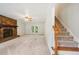 Bright living room featuring a stone fireplace, access to the back deck, and staircase to the second floor at 4772 Ridgewood Nw Ct, Acworth, GA 30102