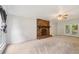 Open living room featuring a stone fireplace, a ceiling fan, and easy access to the backyard deck at 4772 Ridgewood Nw Ct, Acworth, GA 30102