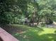An expansive backyard showcasing a small gazebo, mature trees and a fenced boundary at 5607 Mountainbrooke Ct, Stone Mountain, GA 30087