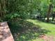 Green backyard with a small shed viewed from the deck at 5607 Mountainbrooke Ct, Stone Mountain, GA 30087