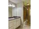 Bathroom featuring an updated vanity, mirror, and shower with yellow tile at 5607 Mountainbrooke Ct, Stone Mountain, GA 30087