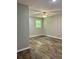 Comfortable bedroom featuring wood-look flooring, a ceiling fan, and neutral wall colors at 5607 Mountainbrooke Ct, Stone Mountain, GA 30087