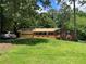 Ranch-style home featuring a brick facade, attached garage, and green lawn at 5607 Mountainbrooke Ct, Stone Mountain, GA 30087