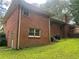 Brick home featuring a well-maintained lawn and an outdoor deck at 5607 Mountainbrooke Ct, Stone Mountain, GA 30087