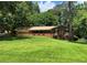Charming brick ranch home with a well-manicured lawn and attached garage on a beautiful sunny day at 5607 Mountainbrooke Ct, Stone Mountain, GA 30087