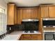 Well-lit kitchen with wood cabinets, stainless steel appliances, and tile backsplash at 5607 Mountainbrooke Ct, Stone Mountain, GA 30087