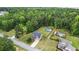 Aerial view of a home with pool and a large, fenced backyard surrounded by lush trees at 572 Boulder View Pkwy, Dallas, GA 30157