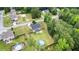 Aerial view of home with a pool, firepit and a large, fenced backyard with trees at 572 Boulder View Pkwy, Dallas, GA 30157