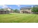 Large grassy backyard with an above ground pool, covered patio and a firepit at 572 Boulder View Pkwy, Dallas, GA 30157