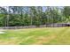 Expansive backyard featuring a large, well-maintained lawn and privacy fence perfect for outdoor activities at 572 Boulder View Pkwy, Dallas, GA 30157