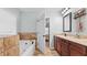 Bathroom with a tub, vanity, and granite countertop at 572 Boulder View Pkwy, Dallas, GA 30157