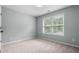 Bright and airy bedroom with neutral carpet and a window providing natural light at 572 Boulder View Pkwy, Dallas, GA 30157
