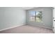 Bright, carpeted bedroom features neutral walls, a window, and great natural light at 572 Boulder View Pkwy, Dallas, GA 30157