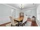 Formal dining area features classic wainscoting, rich hardwood floors, and stylish furnishings at 572 Boulder View Pkwy, Dallas, GA 30157