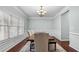 Elegant dining room with wainscoting, chandelier, and a large window for natural light at 572 Boulder View Pkwy, Dallas, GA 30157