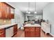 Open-concept kitchen with granite island, stainless appliances, and seamless flow to living area at 572 Boulder View Pkwy, Dallas, GA 30157