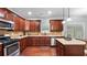 Well-equipped kitchen boasting granite countertops, stainless steel appliances, and dark wood cabinetry at 572 Boulder View Pkwy, Dallas, GA 30157