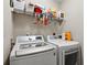 Functional laundry room equipped with modern LG washer and dryer and storage shelving at 572 Boulder View Pkwy, Dallas, GA 30157