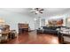 Spacious living room boasting hardwood floors, an upright piano, and a comfortable gray sectional at 572 Boulder View Pkwy, Dallas, GA 30157