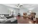 Cozy living room featuring hardwood floors, a stone fireplace, and comfortable gray sectional sofa at 572 Boulder View Pkwy, Dallas, GA 30157