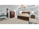 Spacious main bedroom with a tray ceiling, ceiling fan and stylish furniture at 572 Boulder View Pkwy, Dallas, GA 30157