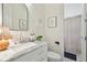 Classic bathroom with marble countertops, framed artwork and mirror, and a sink with modern faucet fixtures at 2112 Murren Se Dr, Smyrna, GA 30080