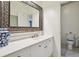 Bright bathroom with a large, ornate mirror over a vanity, and a toilet behind a doorway at 2112 Murren Se Dr, Smyrna, GA 30080