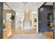 Bright foyer with hardwood floors, staircase, and elegant architectural details at 2112 Murren Se Dr, Smyrna, GA 30080