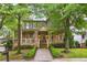 Charming two-story home with a welcoming front porch, stone accents, and lush landscaping at 2112 Murren Se Dr, Smyrna, GA 30080