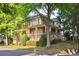 Inviting two-story home exterior with a covered front porch, manicured lawn, mature trees, and well-maintained landscaping at 2112 Murren Se Dr, Smyrna, GA 30080