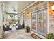 Inviting front porch with stone accents, comfortable seating, and double glass doors at 2112 Murren Se Dr, Smyrna, GA 30080