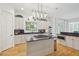 Bright kitchen features an island gas cooktop, stainless appliances, white cabinetry, hardwood floors, and plenty of counterspace at 2112 Murren Se Dr, Smyrna, GA 30080