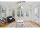 Bright living room features large picture windows, hardwood floors, a ceiling fan, and plenty of natural light at 2112 Murren Se Dr, Smyrna, GA 30080