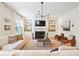 Bright living room has hardwood floors, a fireplace, custom built ins, comfortable seating, and lots of natural light at 2112 Murren Se Dr, Smyrna, GA 30080