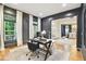 Well-lit home office with dark walls, hardwood floors, and views to the dining room at 2112 Murren Se Dr, Smyrna, GA 30080