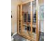 Modern sauna features glass door and a wood interior with bench seating, offering a spa-like experience at home at 2112 Murren Se Dr, Smyrna, GA 30080