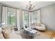 Sitting room with hardwood floors, lots of natural light, a zebra hide rug, and a decorative chandelier at 2112 Murren Se Dr, Smyrna, GA 30080
