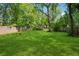 Spacious backyard with lush green grass and mature trees, perfect for outdoor activities at 642 Erin Sw Ave, Atlanta, GA 30310