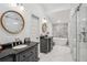 Bright bathroom featuring double sinks, a bathtub, and a glass shower at 642 Erin Sw Ave, Atlanta, GA 30310