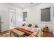 Bright bedroom featuring hardwood floors, a patterned rug, and ensuite bathroom at 642 Erin Sw Ave, Atlanta, GA 30310